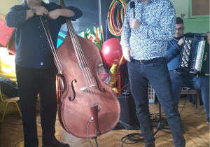 Na zdjęciu znajduje się muzyk grający na kontrabasie oraz Pan Maciej